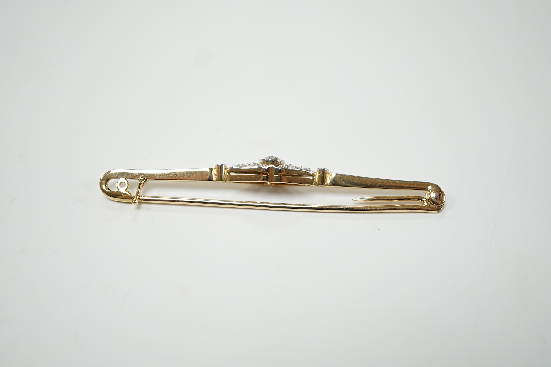 An Edwardian yellow metal and diamond cluster set bar brooch, 55mm, gross weight 3.6 grams. Good condition.